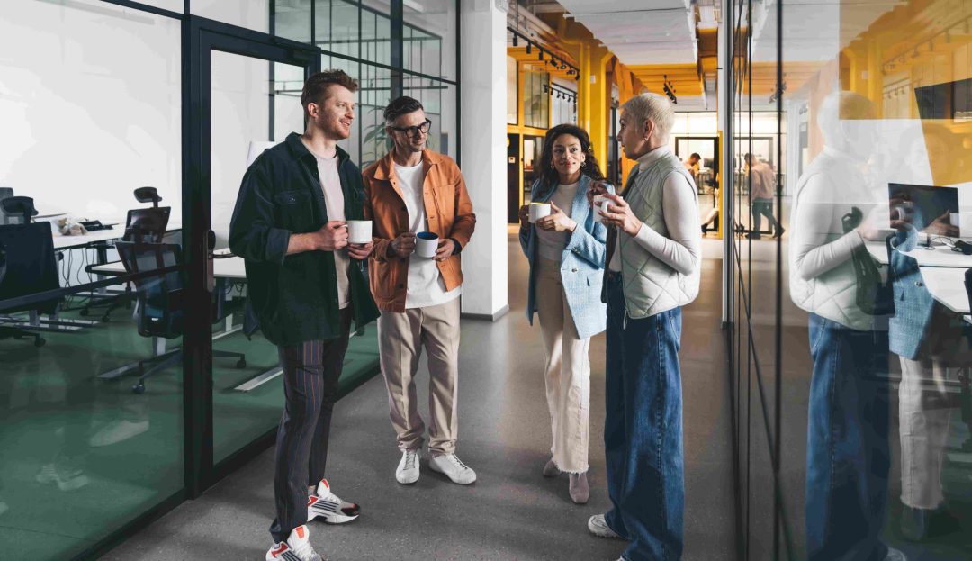 HR people standing in office discussing pay equity