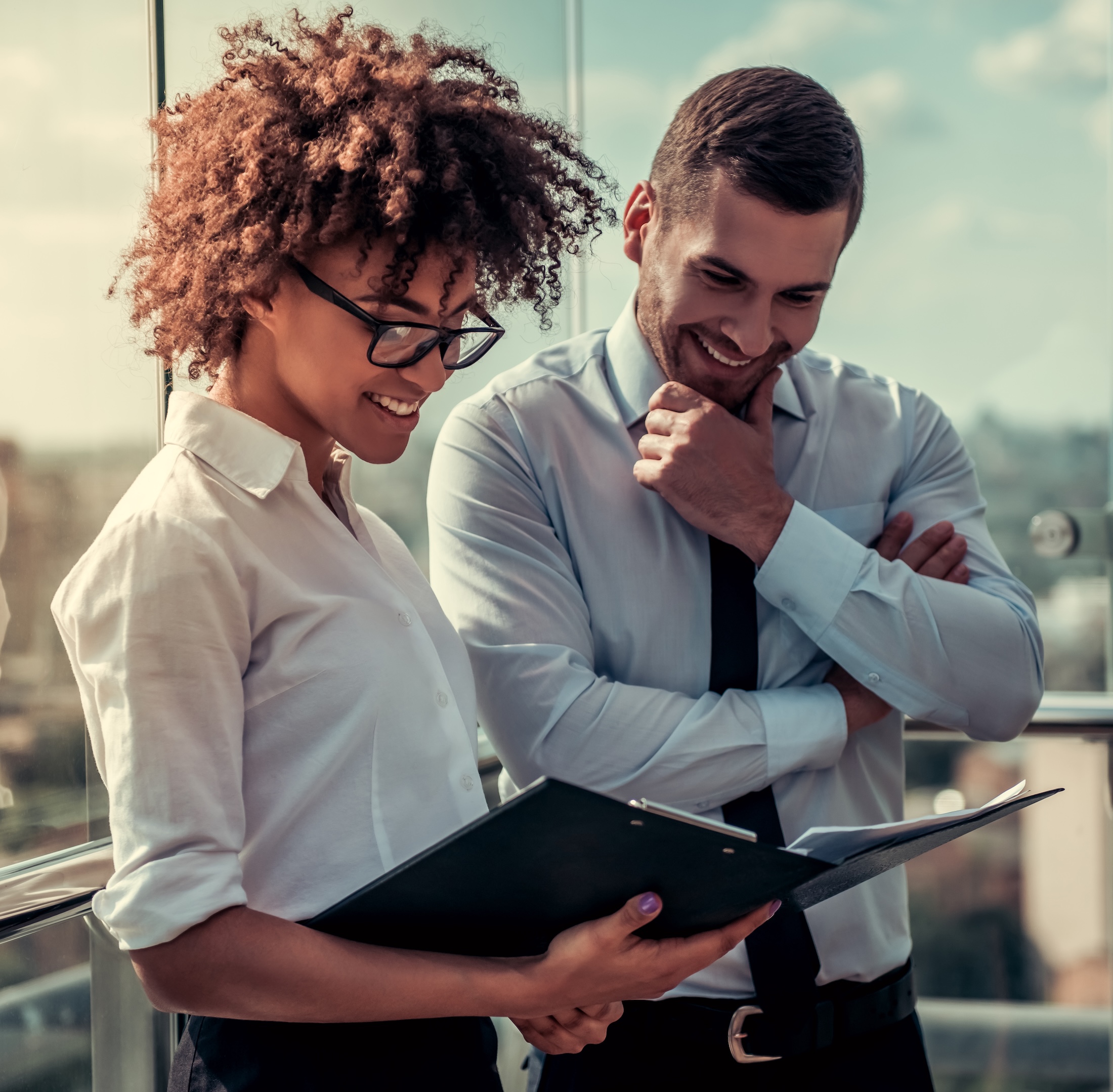 Woman and man reviewing results on a piece of paper and smiling